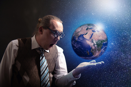 Funny scientist looking to universe and planet earthの写真素材