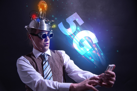 Funny nerd or geek wiith tablet and 5G symbolの写真素材