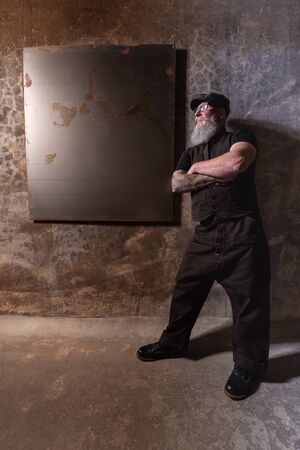 Portrait of bearded hipster with tattooe on his arms.の写真素材
