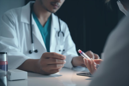 Close-up view of doctors' hands during medication treatment discussionの素材