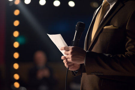 Captivating moment of a keynote speaker delivering a powerful speech at a business conference with bright spotlight on the script and microphone on the podium.の素材