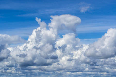 fluffy clouds in the blue skyの写真素材
