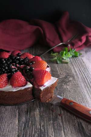 Chocolate cake with whipped cream, strawberries and blueberries.の写真素材