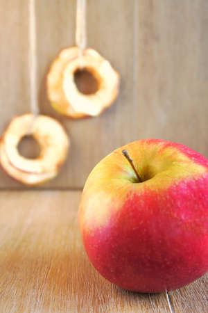 Dry and fresh apples on wooden table.の写真素材
