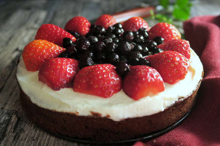 Chocolate cake with whipped cream, strawberries and blueberries.の写真素材