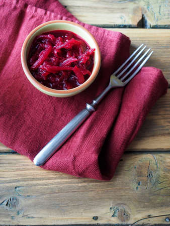 Bowl of sliced beetroot on wooden table.の写真素材