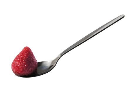 A strawberry in a spoon. Isolated.の写真素材
