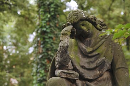 A sculpture of the mourning woman. Old graveyard.の写真素材
