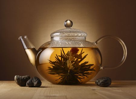 A glass teapot with Lotus Flower Chinese tea.の写真素材