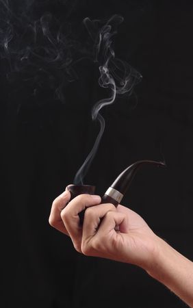 Hand of man with a smoking tobacco-pipe.
