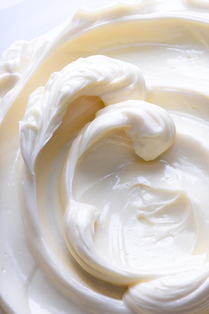 Swirling surface of light beige low-fat milky cream. Close-up photo.の写真素材