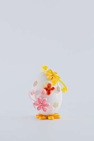 Easter egg on a white background decorated with quillingの写真素材