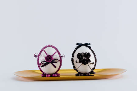 Two Easter eggs on a yellow tray