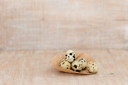 Easter eggs on craft paper on a rustic wooden background with copy space.の写真素材