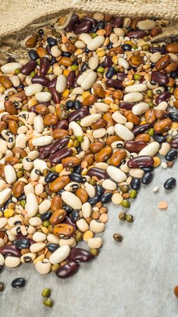 Beans of bean. Background of many grains of dried beans. Brown beans texture. Food background. Close...