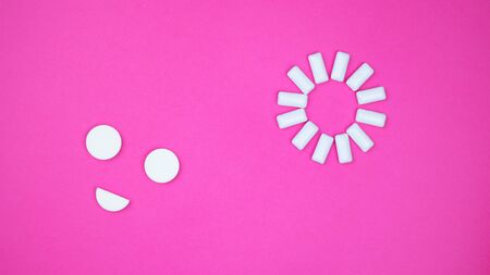 chewing gum on a light pink background. set out in the form of the sun and smiles.の写真素材