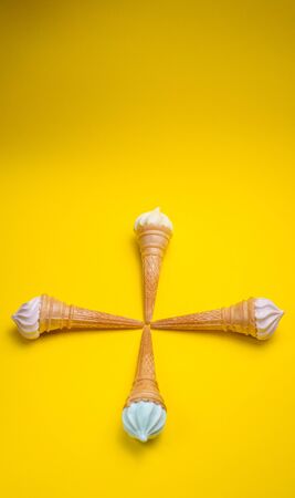 Ice cream cone, summer concept. Ice cream on colored background. Waffle cone with dessert. Side view. Minimal concept.の写真素材