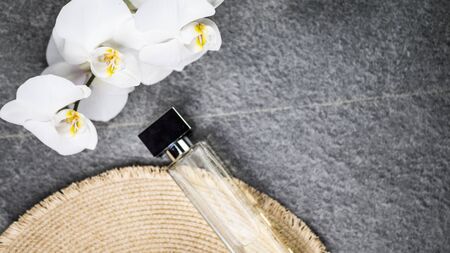 bottle of cologne, flowers on a gray background, Top viewの写真素材