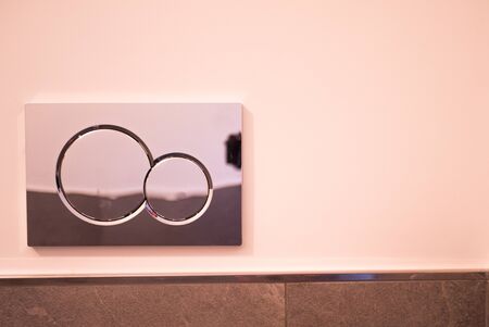 Economic toilet flush press with two separate buttons. Flushing water using dual machanism of concealed toilet cistern. Modern bathroom elements. Clean toilet flush pressの写真素材