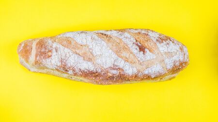 Italian bread on yellow background, Top view
