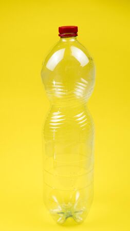 plastic drink bottle isolated closeup on yellow background.の写真素材