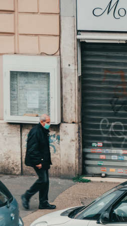 Rome Italy, March - 13, 2020. Man in a protective mask against infectious diseases and as a protection against contamination and influenza. Pandemic coronavirus COVID-19 Romeのeditorial素材