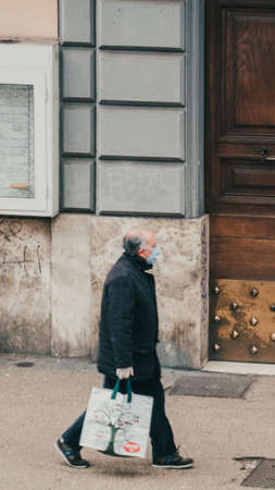 Rome Italy, March - 13, 2020. Man in a protective mask against infectious diseases and as a protection against contamination and influenza. Pandemic coronavirus COVID-19 Romeのeditorial素材