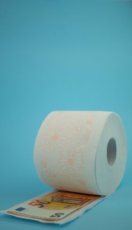 roll of toilet paper on sky blue background and levitating down, copy spece.の写真素材