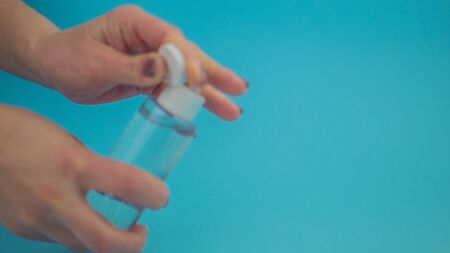 Human hand plastic bottle using alcohol gel to do the cleaning. Concept of pandemic pandemic...