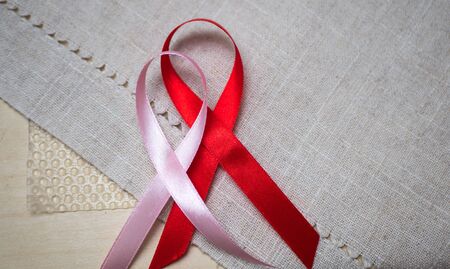 Pink and red ribbon isolated on gray background.の写真素材