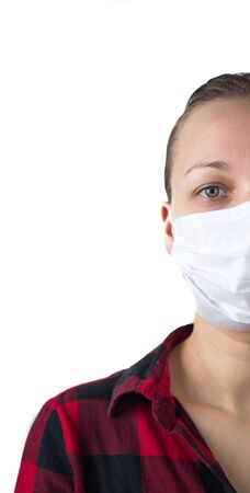Young girl in home clothes with medical mask on face on a white background, medical concept. The girl wears a mask.の写真素材
