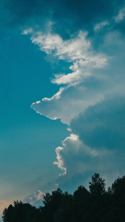 Cumulonimbus cloud formations on tropical blue sky , Nimbus moving , Abstract background from natural phenomenon and gray clouds hunk.の写真素材