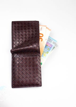 Open wallet with euro banknotes isolated on white background.