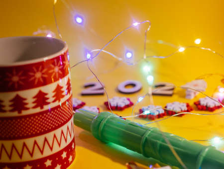 Christmas attributes on a yellow background. Side view, 2021