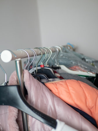 winter and autumn outerwear on hangers, close up