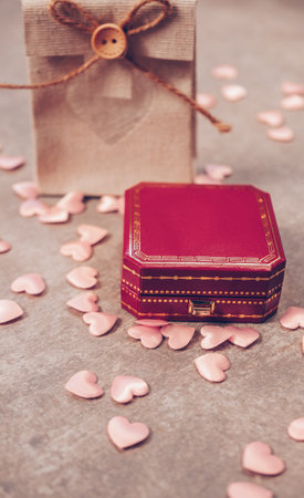 Red box for jewelry with a gift bag, on a gray backgroundの写真素材