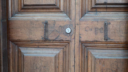 variety of knockers and handles on ancient doors in Italy. Old metal door handle on a wooden door....