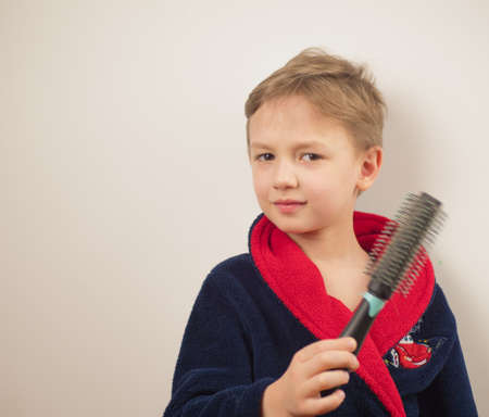 boy in a bathrobe posing at the camera on a white backgroundの写真素材