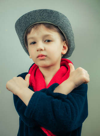boy in a bathrobe posing at the camera on a white background