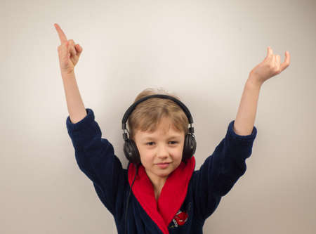 boy in a bathrobe posing at the camera on a white backgroundの写真素材