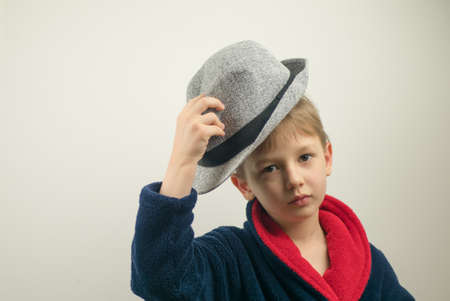 boy in a bathrobe posing at the camera on a white backgroundの写真素材
