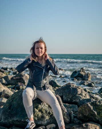 portrait of a girl on a background of the sea. copy spaceの写真素材