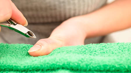 manicure for hands with a nail clipper. close up. Spa at homeの写真素材