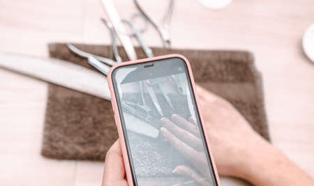 defocus. woman doing photo manicure at home