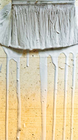 gray paint flows from the brush. close upの写真素材