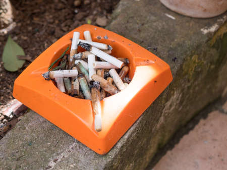 Man smoking cigarette and using an ashtrayの写真素材
