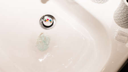 Toothpaste With Blood in the Sink. Blood When Brushing Teeth. Blood in the Foamの写真素材