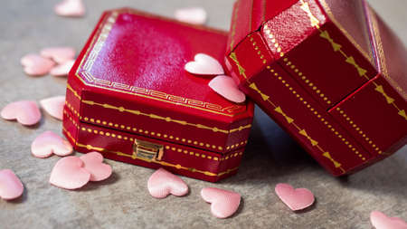 Red box for jewelry with a gift bag, on a gray background