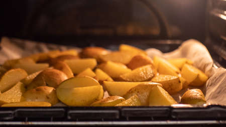 potatoes are fried in the oven, close upの写真素材