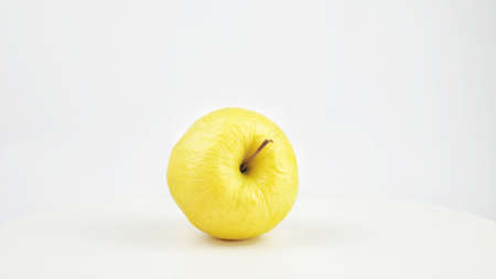 Ripe yellow apple isolated on a white background.の写真素材